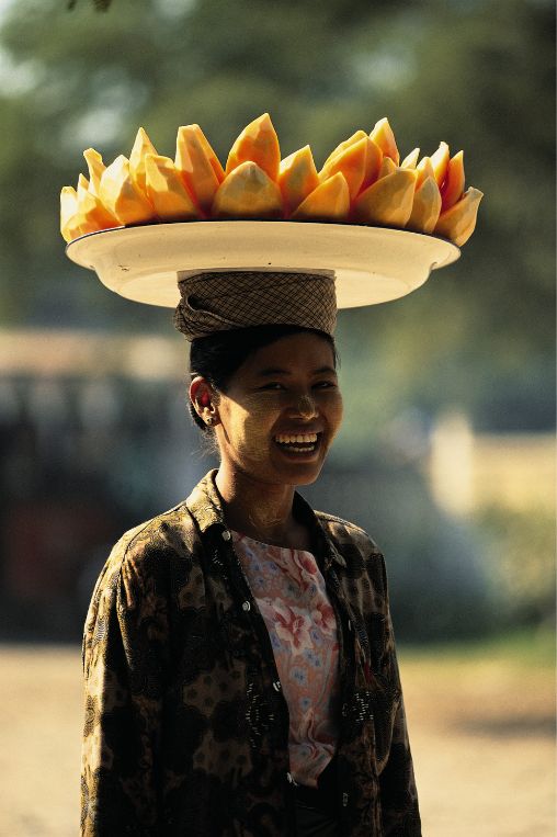 woman balancing a platter of fruit Myanmar
