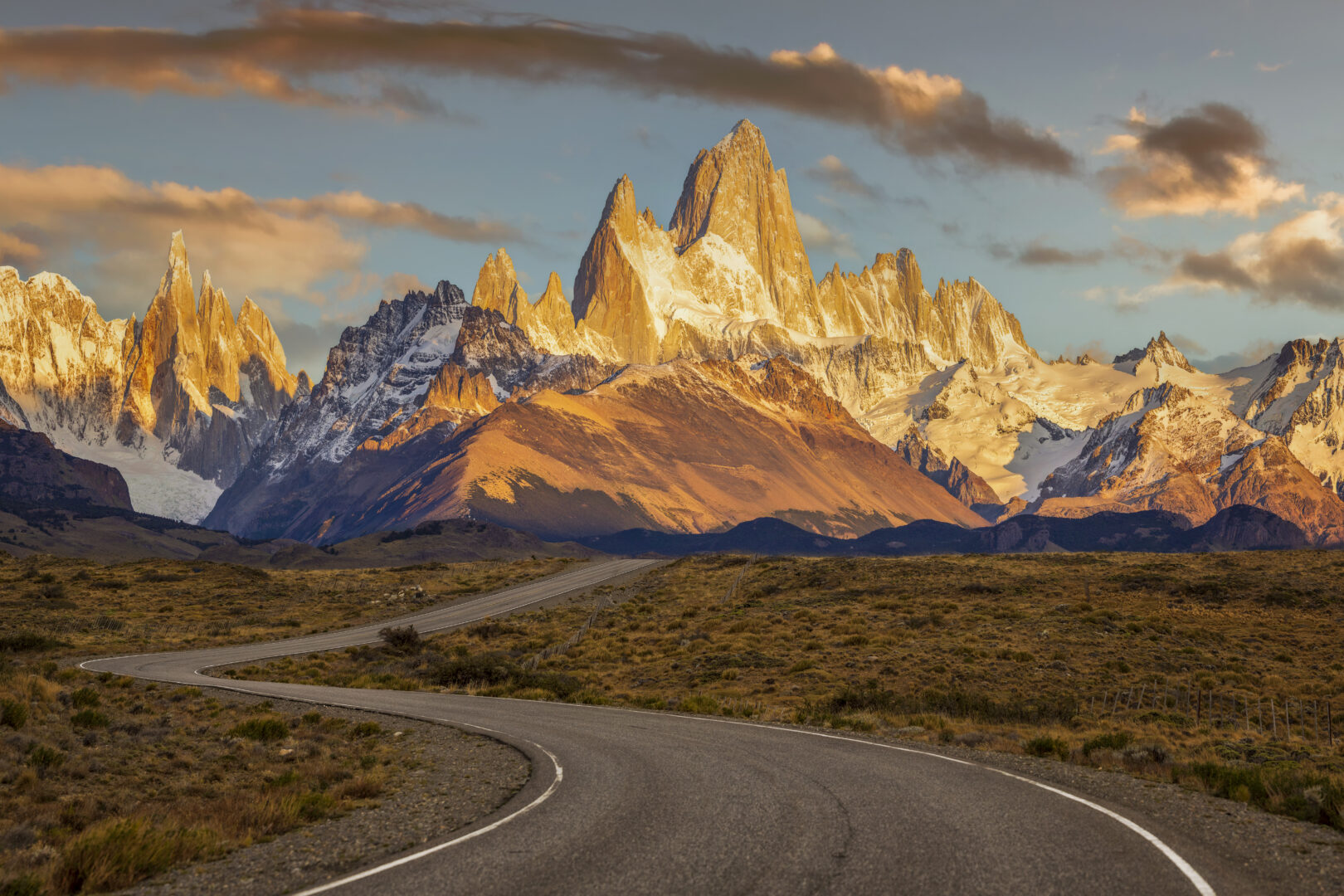 A windy road leads to Mt. Fitz Roy, surrounding mountains and the town of El Chalten, Patagonia