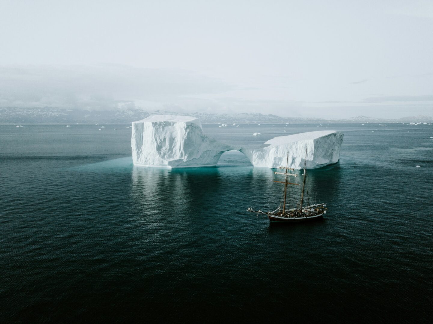 Luxury expedition boats navigating among floating icebergs in the Arcti
