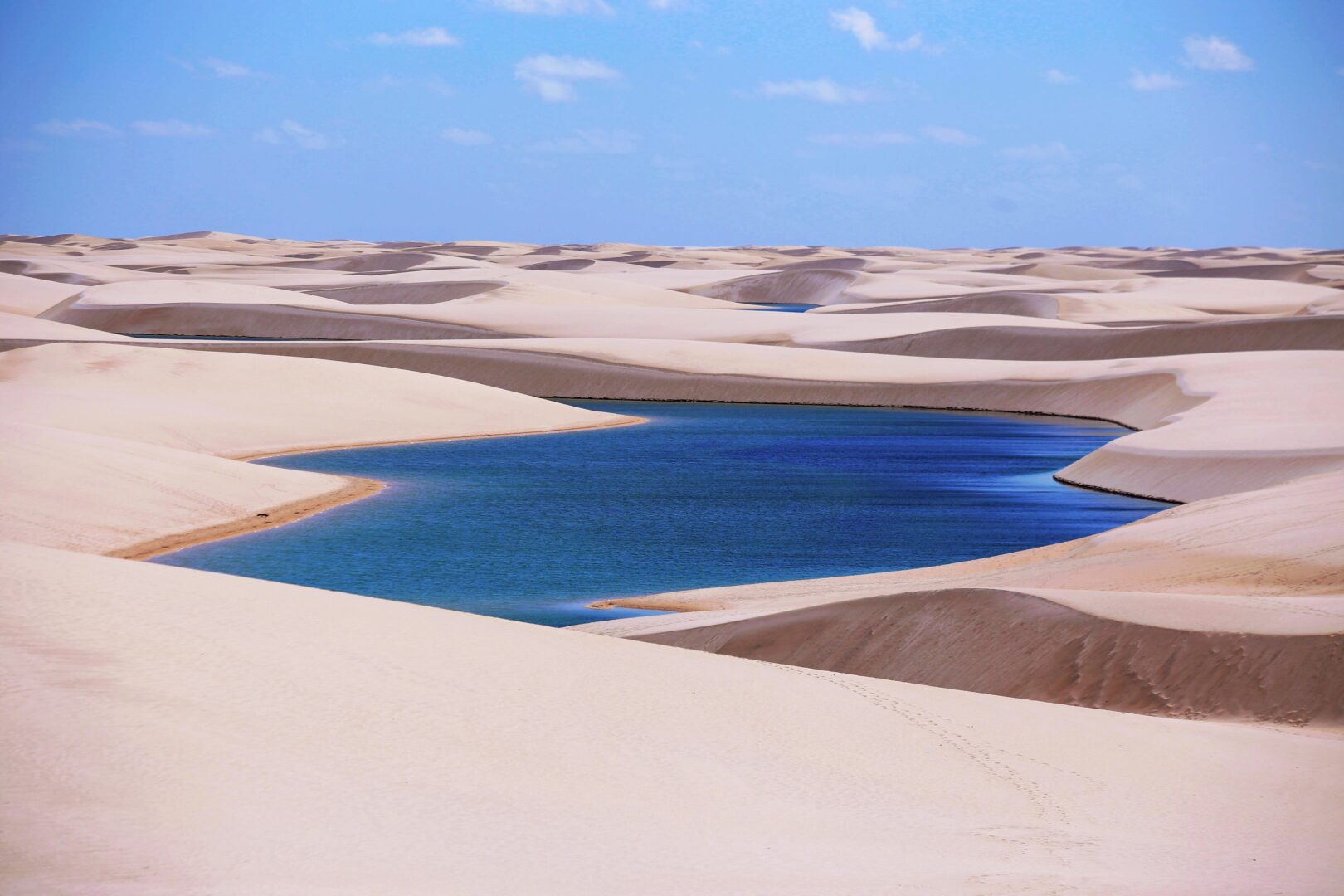 Dunes and lagoons of Lencois Maranhenses, Brazil. Intense blue water and white sand at the afternoon.