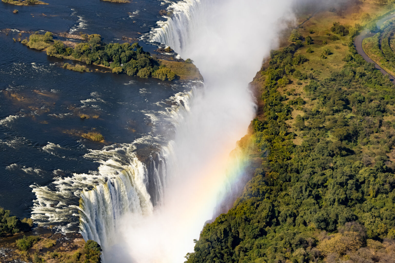 Helicopter view of the magnificent Victoria falls in Africa with a rainbow