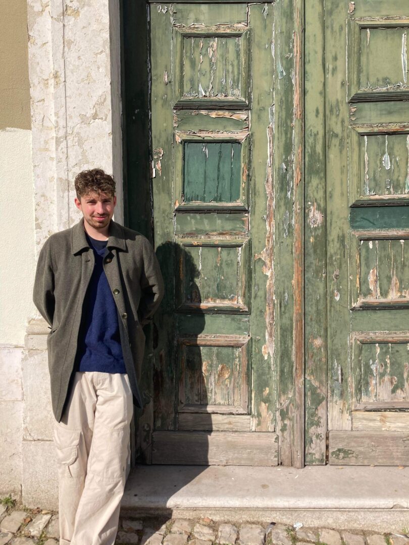 Cameron Arthur standing in front of rustic door