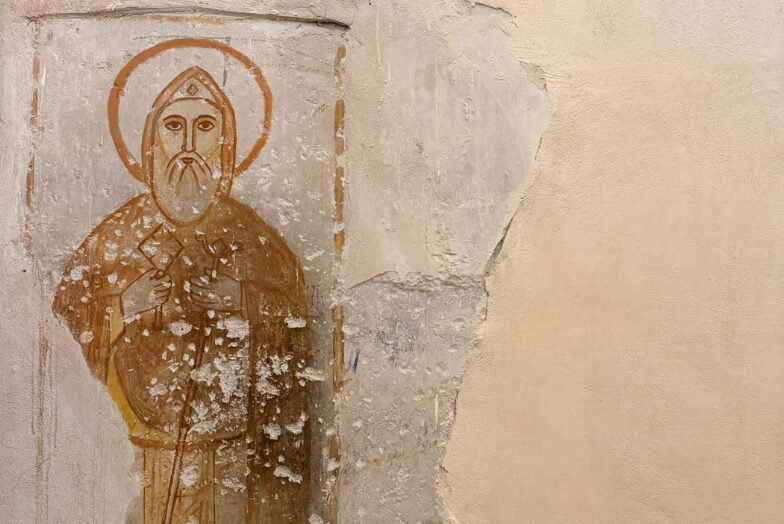 A faded desert saint emerges from centuries-old plaster, a silent witness to the long monastic tradition of Wadi El Natrun